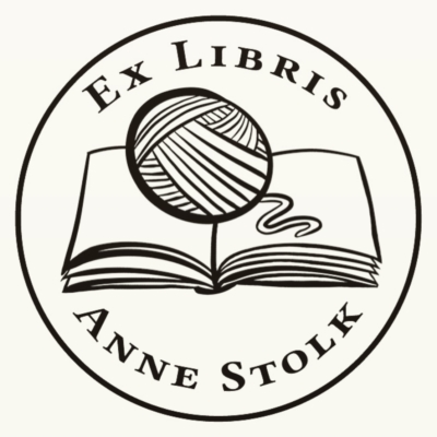 An illustrated logo of an Ex Libris stamp depicting an open book with a ball of yarn on top